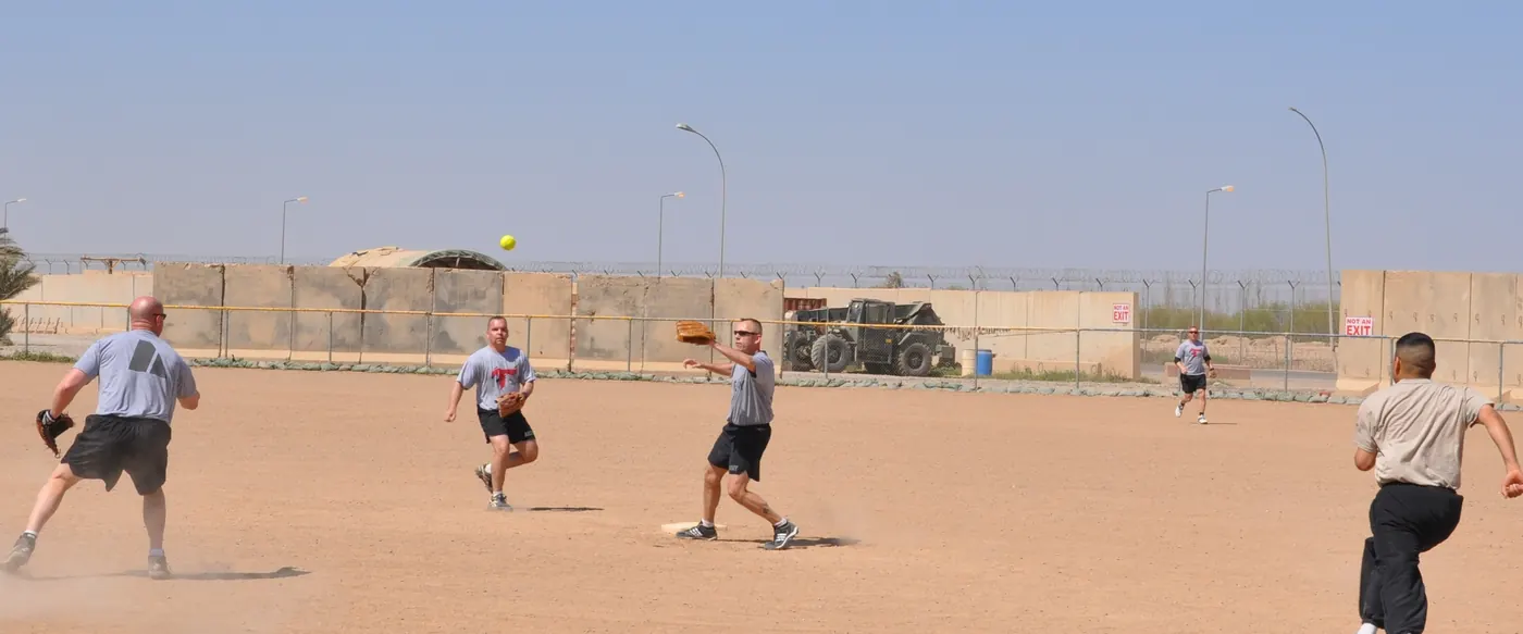 A batter at the plate during an adult softball game